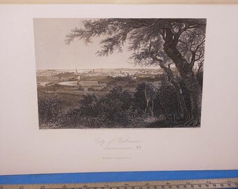 May include: A black and white landscape print titled "City of Baltimore". The print depicts a cityscape with buildings and a body of water, framed by trees in the foreground. The print is on a white background.