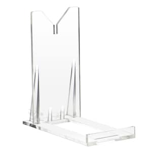 May include: Clear acrylic display stand with a rectangular base and a vertical back support. The back support has a V-shaped top and two angled supports. The stand is designed to hold a plate or other display item.