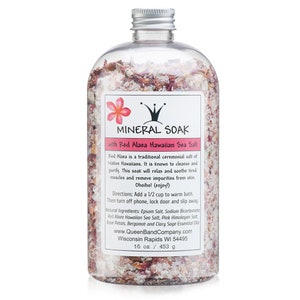 May include: A clear plastic bottle filled with pink bath salts and rose petals. The label reads "Mineral Soak with Red Alaea Hawaiian Sea Salt". The bottle is 16 ounces or 453 grams.