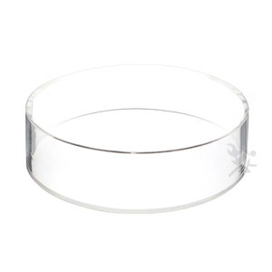 May include: A clear acrylic round display stand. The stand is approximately 6 inches in diameter and 2 inches tall.