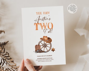 May include: A printable invitation for a child's second birthday party with a cowboy theme. The invitation features a watercolor illustration of a cowboy hat, boots, and a wagon wheel. The text on the invitation reads "Yee Haw Austin's Two Y'all!"