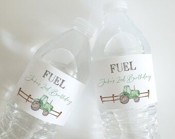 May include: Two clear plastic water bottles with white labels. The labels have a green tractor illustration and the text "FUEL" and "Jake's 2nd Birthday".