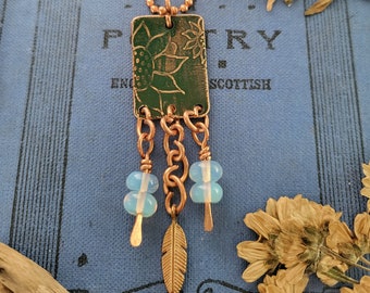 Copper sunflower mixed metal necklace with opalite and feather charms, green patina pendant