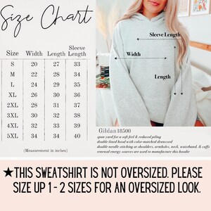 May include: A light gray hoodie with a size chart and text. The size chart shows measurements in inches for width, length, and sleeve length, ranging from size S to 5XL. The text reads: "THIS SWEATSHIRT IS NOT OVERSIZED. PLEASE SIZE UP 1-2 SIZES FOR AN OVERSIZED LOOK."