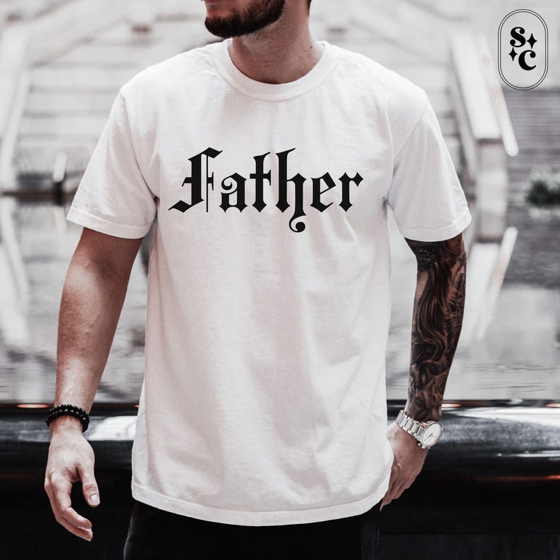 May include: White t-shirt with a black "Father" graphic in a gothic font.