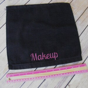 May include: Black cotton makeup remover towel with pink embroidery that says "Makeup".