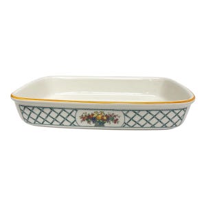 May include: A rectangular ceramic baking dish with a cream-colored interior and a yellow rim. The exterior features a dark green lattice pattern and a central oval medallion depicting a colorful arrangement of assorted fruits in a basket.