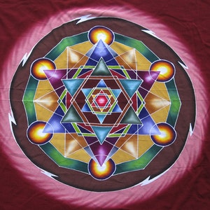 May include: A colorful mandala with a geometric design featuring a star, triangles, and circles. The mandala is painted on a red fabric background.