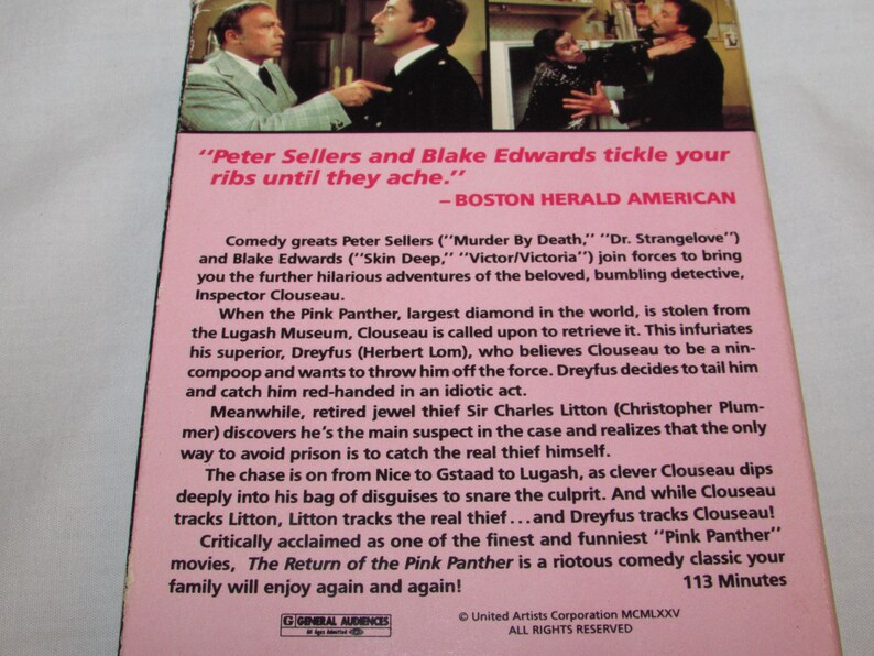 May include: The back of a VHS tape for "The Return of the Pink Panther" movie. The pink background features text about the film's plot, cast, and critical acclaim. The top of the tape shows a scene from the movie.