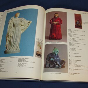 May include: A book page showing a collection of porcelain figurines. The figurines are of a woman in a white dress, a man in a red robe, and a man in a blue robe. The book page also includes text describing the figurines.