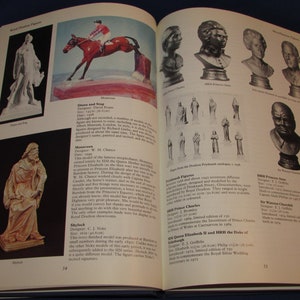 May include: A book open to two pages showing a collection of Royal Doulton figurines. The figurines are made of porcelain and depict historical figures such as Queen Elizabeth II, Prince Charles, and Winston Churchill. The book includes descriptions of each figurine, including the designer, date, and size.