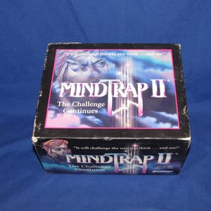 May include: A white ceramic mug with a black handle and the text "But First, Coffee" in a handwritten style. The mug is on a white surface. The mug is approximately 4 inches tall.