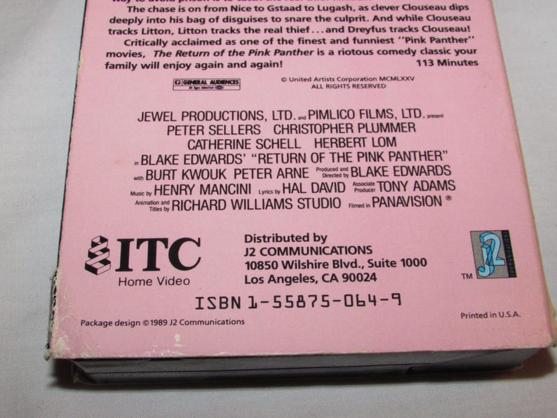 May include: A pink VHS tape for "The Return of the Pink Panther" movie. The cover features the film's title and credits, including Peter Sellers and Blake Edwards. The tape is distributed by J2 Communications.