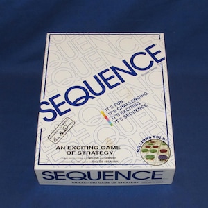 May include: A white board game box with the word "SEQUENCE" in large blue letters. The box also features the text "AN EXCITING GAME OF STRATEGY" and "MILLIONS SOLD". The game's description includes "IT'S FUN, IT'S CHALLENGING, IT'S EXCITING, IT'S SEQUENCE".