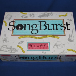 May include: A white box with a pink and yellow design for the board game SongBurst 50's & 60's Edition. The game is a complete-the-lyric game.