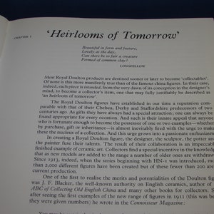 May include: A book titled 'Heirlooms of Tomorrow' with a quote from Longfellow about the beauty of objects made from common clay. The book discusses the history of Royal Doulton figures and their appeal as collectibles.