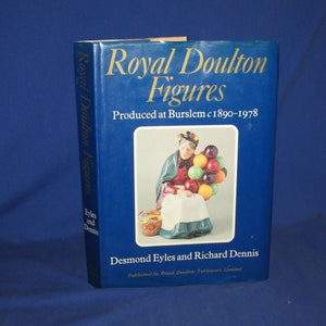 May include: A blue book titled "Royal Doulton Figures" with a picture of a woman holding a bunch of colorful balloons. The book was produced in Burslem, England from 1890 to 1978. The authors are Desmond Eyles and Richard Dennis.