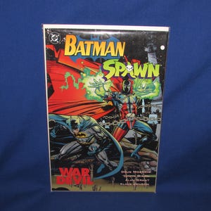 May include: Comic book cover featuring Batman and Spawn. The cover art depicts the characters in action, with Batman in a gray and black suit and Spawn in a red and black costume. The title "Batman Spawn" is prominently displayed.