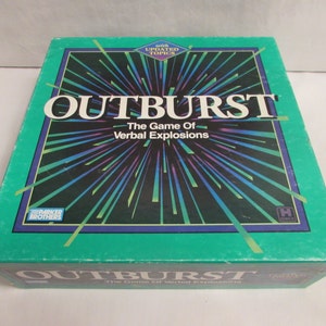 May include: A vintage board game box for "OUTBURST," featuring a teal green background with a burst of colorful lines radiating from the center. The game title is in large white letters, with the tagline "The Game Of Verbal Explosions."