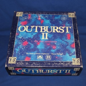 May include: A vintage board game box for "Outburst II." The box has a dark blue background with a colorful abstract design in shades of blue and red. The game title is prominently displayed in white, with the text "...the fun continues" below.