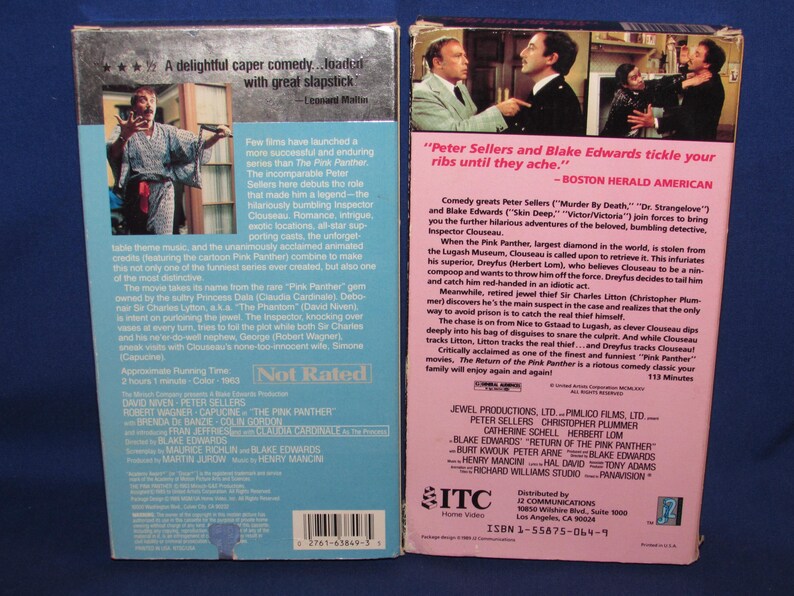 May include: Two VHS video cassette tapes for the movie "The Return of the Pink Panther." The tapes have colorful labels with movie details, cast, and reviews. The background is a blue surface.