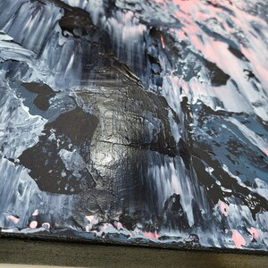 May include: Abstract painting on canvas with a black, white, pink, and blue color scheme. The paint is applied in thick layers, creating a textured surface.