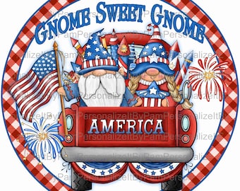 May include: A red, white, and blue gnome themed truck with the words "Gnome Sweet Gnome" and "America" on the side. The truck is decorated with fireworks and stars. Two gnomes are riding in the truck, one with a red hat and the other with a blue hat.