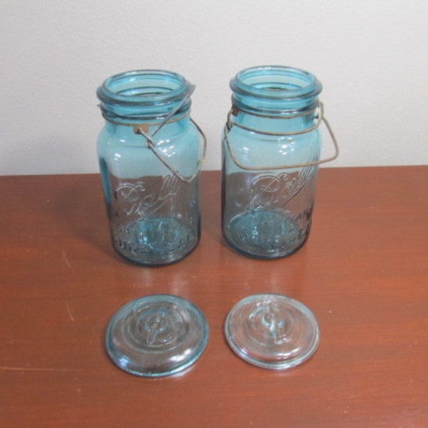 Wire hinged BALL quart-sized jars x 2; blue canning jars; metal wire lid; hinged closing; rusted patina;  sanitary sure seal; 1940's