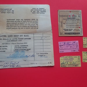 May include: A collection of vintage train tickets and travel documents on a red background. The documents include a Union Pacific Railroad transfer coupon, Pullman Company tickets, and a Chicago Railways' Hotel ticket.