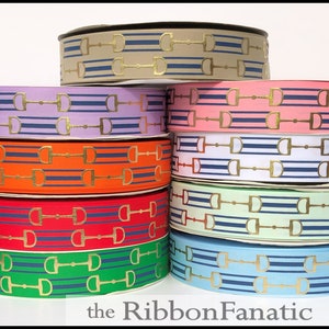 May include: A stack of eight spools of ribbon with a gold horse bit pattern on a white background. The ribbon is in various colors including beige, lavender, pink, white, orange, red, green, and light blue. The text "the Ribbon Fanatic" is at the bottom of the image.