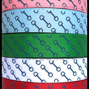 May include: Five spools of ribbon with a repeating pattern of blue horse bits on a white, red, green, light blue, and pink background. The spools are stacked on top of each other. The text "the Ribbon Fanatic" is visible at the bottom of the image.