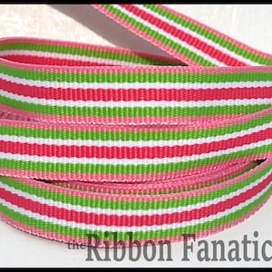 May include: Pink, green, and white striped ribbon. The ribbon is woven with a textured pattern. The ribbon is folded in half and the ends are visible.