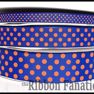 May include: Three spools of blue and orange polka dot ribbon. The ribbon is 1.5 inches wide and is perfect for crafting, decorating, and gift wrapping.