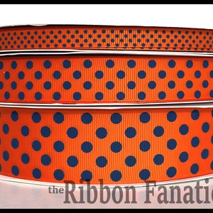 May include: Three rolls of orange and navy blue polka dot ribbon. The ribbon is 1.5 inches wide.