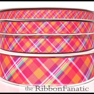 May include: Four spools of colorful plaid ribbon. The ribbon features a vibrant pattern of pink, orange, yellow, green, and purple. The text "the RibbonFanatic" is visible at the bottom of the image.