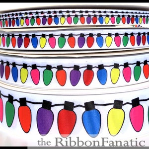 May include: White ribbon with a repeating pattern of colorful light bulbs. The ribbon is available in different widths. The text "the Ribbon Fanatic" is printed at the bottom of the image.