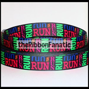 May include: Black ribbon with the word "RUN" repeated in various colors, including pink, green, blue, and orange.
