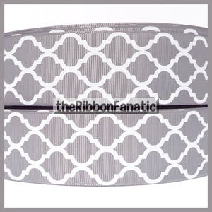 May include: Gray and white patterned ribbon with a geometric design. The ribbon is 2.5 inches wide and is perfect for crafting, decorating, and gift wrapping.