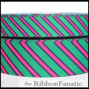 May include: Green and pink striped ribbon with diagonal stripes. The ribbon is 1.5 inches wide.