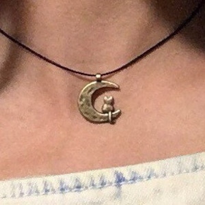 moon cat choker ; bronze kitty sitting on a crescent moon on a 1 mm waxed cotton cord ; unique space kitten jewelry ; gifts for ladies