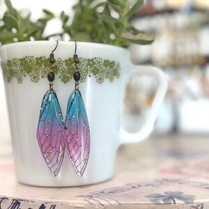 resin dragonfly wings - pink blue & clear w/gold flecks, subtle bi pride flag cicada earrings - gifts for sisters teens witchy friends