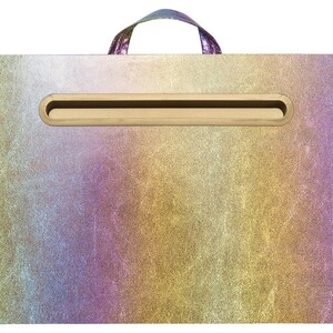 May include: A gold, purple, and blue iridescent laptop desk with a built-in handle and a slot for a tablet or phone.