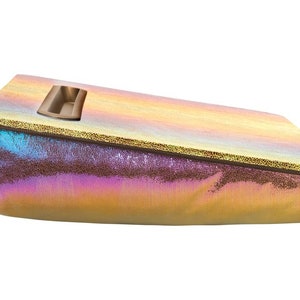 May include: A iridescent gold and purple pillow with a built-in tray. The tray is made of a light brown material and has a rectangular shape.