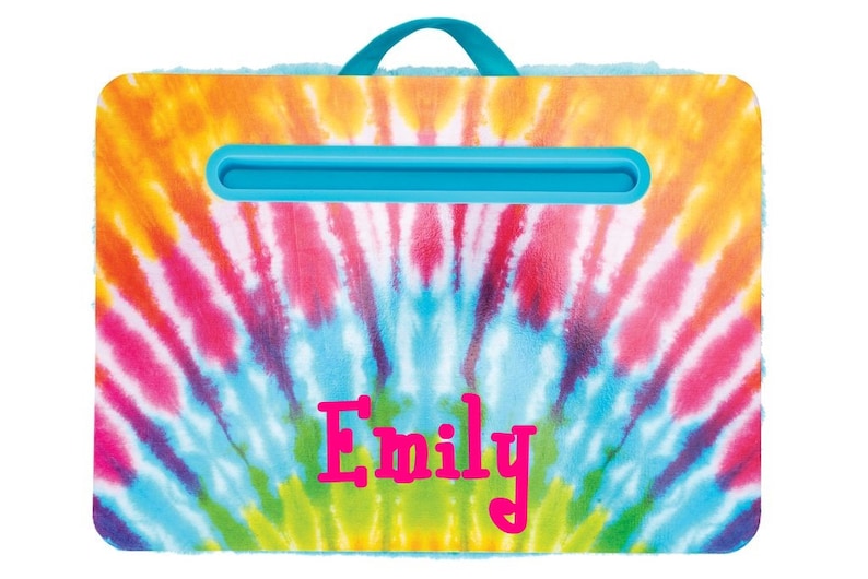 May include: A blue and white tie-dye patterned lap desk with a blue handle and a built-in book holder. The name "Emily" is printed in pink on the front of the desk.