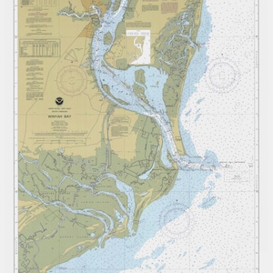 May include: A nautical chart of Winyah Bay, South Carolina, featuring detailed depictions of the coastline, waterways, and depth soundings. The chart uses blue, green, and tan colors to represent the water, land, and shallows, respectively. Text includes "Winyah Bay" and other navigational details.