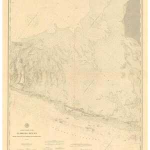 May include: A vintage nautical chart of Florida Reefs from Long Key to Newfound Harbor Key. The chart is printed on cream-colored paper with brown and black lines and text. The chart includes compass roses, depth soundings, and navigational information.