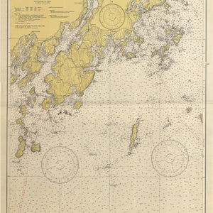 May include: A nautical chart of Muscle Ridge Channel in Maine, showing the coastline, islands, and depths of the water. The chart is printed on a beige background with brown and yellow lines and text. The chart includes a compass rose and a scale bar.