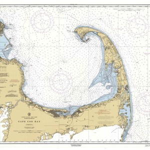 May include: A nautical chart of Cape Cod Bay, Massachusetts. The chart shows the coastline, inlets, and waterways of the bay. The chart is printed in black and white with blue and light blue markings. The chart is titled "Cape Cod Bay" and includes a legend and scale.