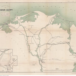 May include: A vintage map of Lower Egypt, showing the Nile River and surrounding areas. The map is in shades of green, brown, and white, with text labels in black. The map includes a smaller inset map of the area around Cairo.