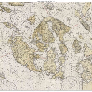May include: A vintage nautical chart of the San Juan Islands, Washington State, with detailed coastline and island features. The chart includes depth soundings, navigational aids, and other important information for mariners. The title "Nautical Chart of the San Juan Islands 1913" is printed at the top.